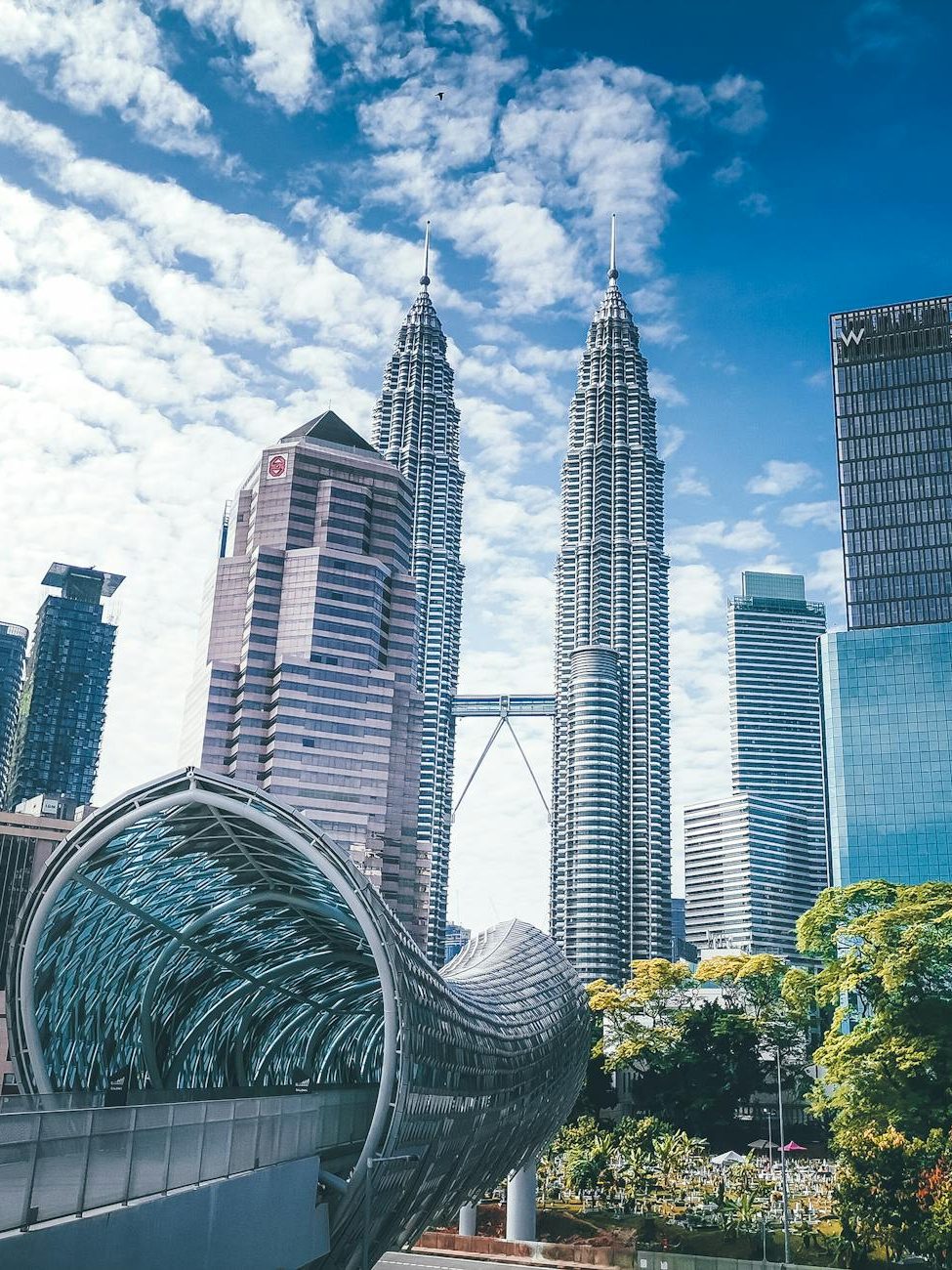 modern urban city with glass skyscrapers and pedestrian overpass